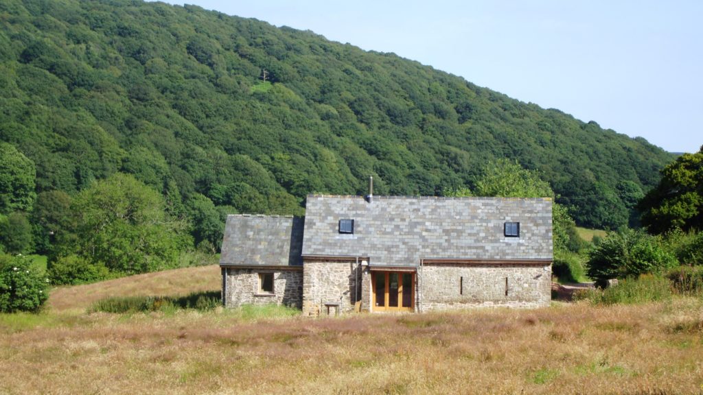 The Old Barn, one of our holiday cottages in the Brecon Beacons with Deri hill behind